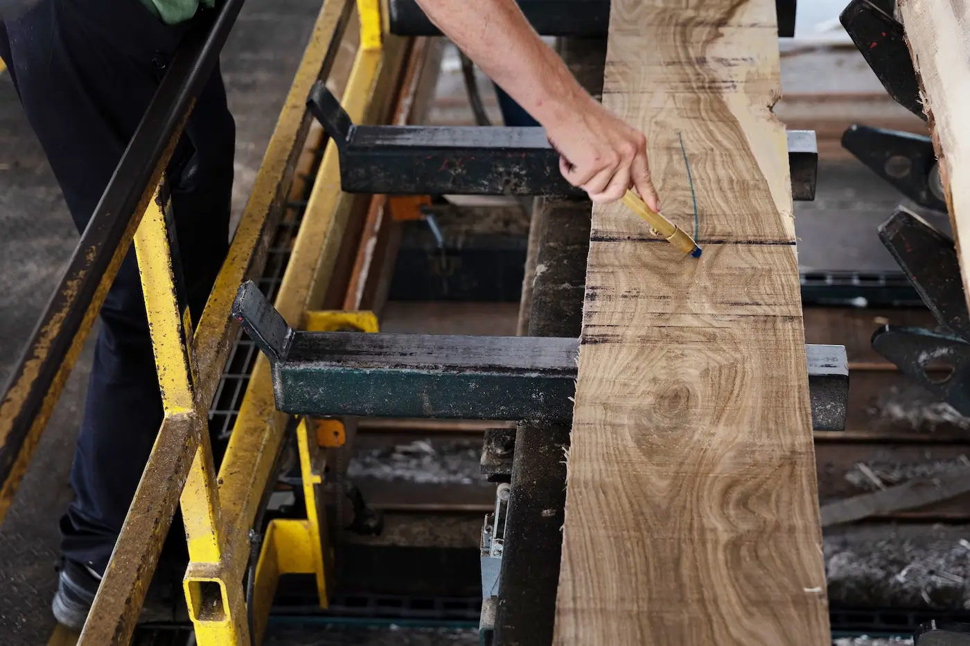 Stoltzfus Hardwood's employee marking a piece of wood.